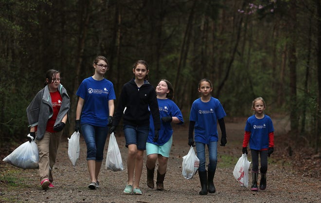 (L-R) Maddie Adams (10), Annabel Egger (13), Adeline Egger (11), Matti Cate (10), Leah Treat (11) and Maelin Treat (7) with American Heritage Girls Troop 0512 walk the trail at South Fork River Park early Saturday morning, March 19, 2016 looking for trash to pickup as part of the Adopt a Park program. MIKE HENSDILL/THE GAZETTE