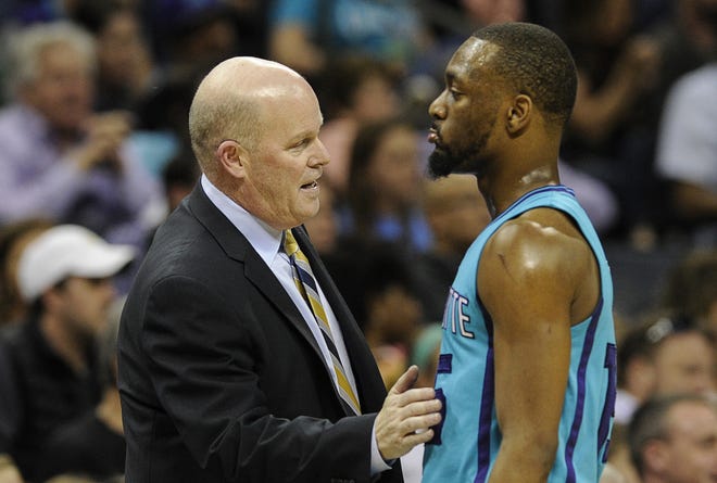 Hornets coach Steve Clifford talks to guard Kemba Walker during Saturday's game against the Nuggets in Charlotte. Clifford said the Hornets are focused on locking up a playoff berth. AP Photo/Mike McCarn