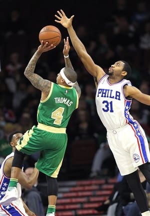 76ers guard Hollis Thompson (31) tries to block a shot by Celtics guard Isaiah Thomas (4) in the first half of Sunday's game. AP Photo/Laurence Kesterson