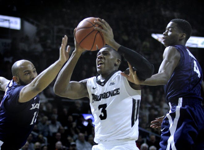 Kris Dunn, driving through two Xavier defenders in January game, helped lead the PC Friars to the second round of the NCAA Tournament this season.