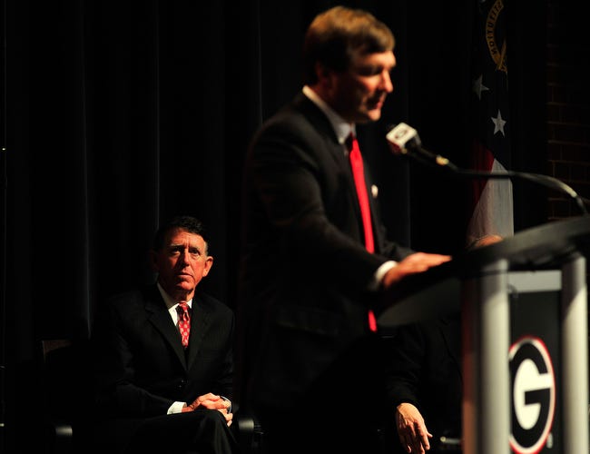 Athletic Director Greg McGarity, left, listens as Kirby Smart speaks following a press conference naming him the new UGA Head Football Coach at the Georgia Center on Monday, Dec. 7, 2015 in Athens, Ga. (Richard Hamm/Staff) OnlineAthens / Athens Banner-Herald
