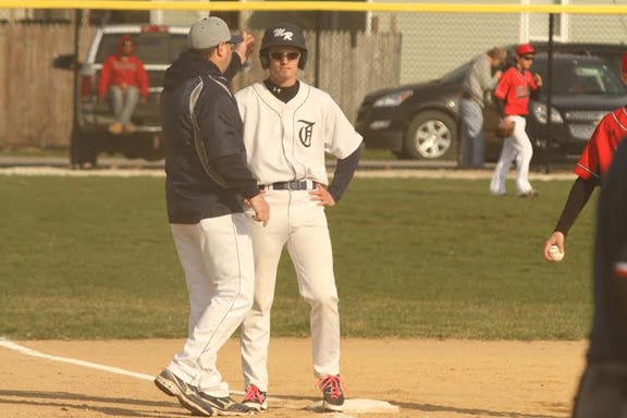 Monmouth-Roseville coach Jim Cole congratulates Caleb Empson on Monday afternoon in a 9-0 victory over North Fulton.  RUTH KENNEY/REVIEW ATLAS