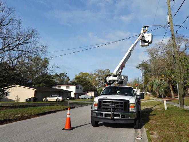 Above: Bill Delk, a construction and maintenance foreman with the JEA, installs a new LED streetlight Wednesday on Volvo Street in Jacksonville.  Left: Delk checks out a new LED streetlight he just installed.  Photos by Will.Dickey @jacksonville.com