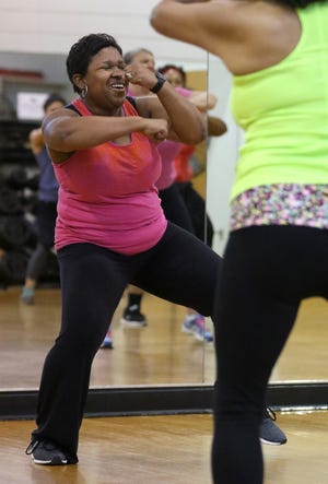 Zenitra McGrinson leads a Zumba class at the Central YMCA on West Franklin Blvd. early Friday morning, March 18, 2016. MIKE HENSDILL/THE GAZETTE