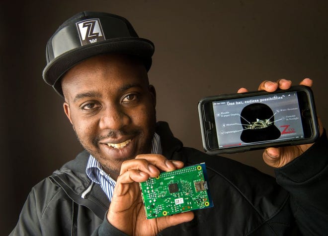 Jamaal Crayton wears a prototype of a ball cap that will feature a live display that allows the wearer to change the graphics on the hat in real-time, synced to their phone. The Zero Wearables hat eventually will use a flexible paper display that can be built into the front of the hat.