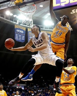 FILE - In this Nov. 13, 2015, file photo, LSU forward Ben Simmons (25) goes to the basket against McNeese State forward Austin Lewis (44) in the second half of an NCAA college basketball game in Baton Rouge, La. LSU freshman forward Ben Simmons, who led the Tigers in scoring, rebounds and assists this season, says he is leaving the Tigers to turn pro. Simmons, who made his announcement in an interview published Monday, March 21, 2016, by ESPN, says he will soon hire an agent and enter the NBA draft, for which Simmons has been widely projected as a top overall pick.