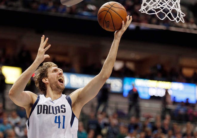 Dallas Mavericks forward Dirk Nowitzki (41) attempts a layup during the second half of a game against the Portland Trail Blazers on Sunday, March 20, 2016, in Dallas. Dallas won in overtime, 132-120.