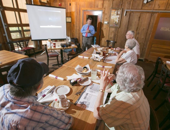 John Young of Freedom Health makes a presentation to seniors about Freedom Health's Medicare Advantage plans during a meeting at Logan's Roadhouse in Ocala in July 2014.
