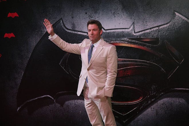 Ben Affleck, cast as Batman, waves during a red carpet event promoting “Batman v Superman: Dawn of Justice.“