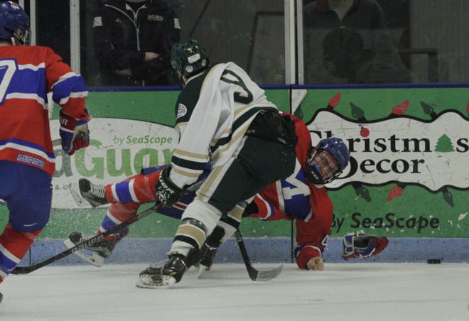 Hendricken's Brandon Waterman (9) sends Mount St. Charles' Jack Boisvert to the ice during a game in February at URI's Boss Arena. The Hawks and Mounties will play for the state championship beginning on Wednesday.
