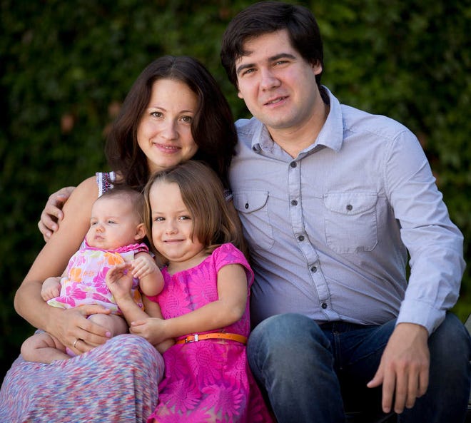 FILE - In this 2014 file photo, award-winning concert pianist Vadym Kholodenko, poses with his wife Sofya Tsygankova and daughters Nika, 4, and Michela, at their home in Fort Worth, Texas. Police say the two daughters of Kholodenko have been found slain in their Texas home, Thursday, March 17, 2016, and the musician's estranged wife is being treated for stab wounds. Benbrook police Cmdr. David Babcock said Friday that Kholodenko is not a suspect and that his spouse faces a mental health evaluation. (Joyce Marshall/Star-Telegram via AP) MAGS OUT; (FORT WORTH WEEKLY, 360 WEST); INTERNET OUT; MANDATORY CREDIT