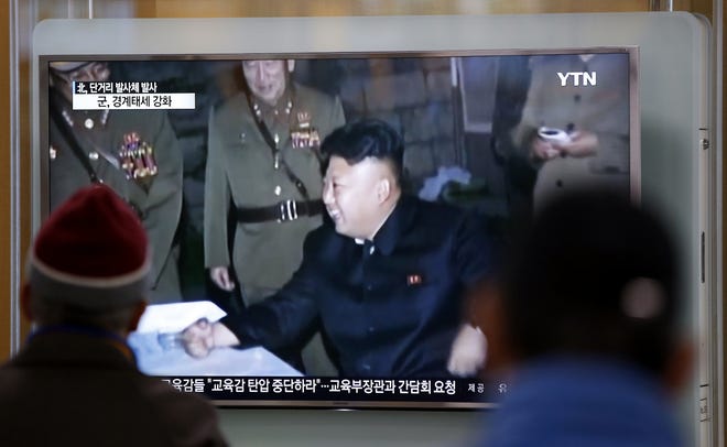 People watch a TV news program showing North Korean leader Kim Jong Un at Seoul Railway Station in Seoul, South Korea, Monday, March 21, 2016. North Korea fired five short-range projectiles into the sea on Monday, Seoul officials said, in a continuation of weapon launches it has carried out in an apparent response to ongoing South Korea-U.S. military drills it sees as a provocation. (AP Photo/Lee Jin-man)