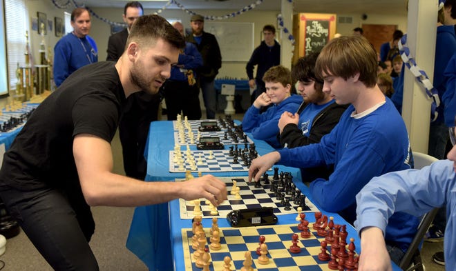 International Grandmaster chess player Cristian Chirila takes on four students of New Hope Academy in timed chess games at the Motivational Educational Training Company in Lower Makefield. Chirila beat all four on 5 minute timers.