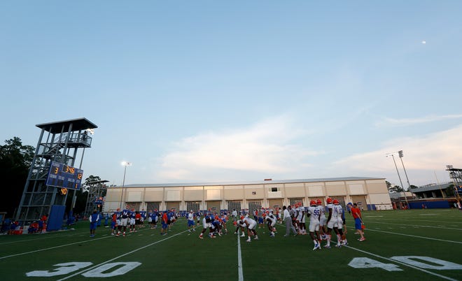 Florida players practice on the field next to the new indoor facility on campus.
MATT STAMEY/STAFF PHOTOGRAPHER