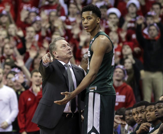 FILE - In this Jan. 17, 2016, file photo, Michigan State coach Tom Izzo talks with Deyonta Davis during an NCAA college basketball game against Wisconsin, in Madison, Wisc. Michigan State coach Tom Izzo says he will assist freshman Deyonta Davis as he considers entering the NBA draft. Izzo had a news conference Tuesday, wrapping up a season that ended with a stunning loss to Middle Tennessee State in the first round of the NCAA Tournament. (AP Photo/Andy Manis)