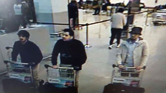 This image provided by the Belgian Federal Police in Brussels on Tuesday shows three men who are suspected of taking part in the attacks at Belgium's Zaventem Airport. The man at right is still being sought by the police and two others in the photo that the police issued were according to a the Belgian Prosecutors 'probably' suicide bombers. Bombs exploded at the Brussels airport and one of the city's metro stations Tuesday, killing and wounding scores of people, as a European capital was again locked down amid heightened security threats.