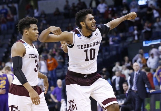 Texas A&M guard Admon Gilder (3) and center Tonny Trocha-Morelos (10) celebrate at the end of Sunday's win over Northern Iowa in the second round of the NCAA Division I men's basketball tournament. AP photo