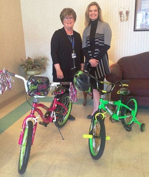 Pictured with the bikes to be raffled are Lori Ryan, left, in marketing with Preferred Home Health Care and Pharmacy; and Deann Schweitzer, community relations coordinator with Toulon Rehabilitation and Health Care.