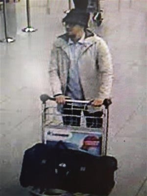 In this image provided by the Belgian Federal Police in Brussels on Tuesday, March 22, 2016, a man who is suspected of taking part in the attacks at Belgium's Zaventem Airport and is being sought by police. Bombs exploded at the Brussels airport and one of the city's metro stations Tuesday, killing and wounding scores of people, as a European capital was again locked down amid heightened security threats. (Belgian Federal Police via AP)
