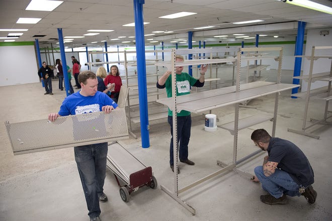 Volunteers, Restore employees and Univest Bank and Trust Co. volunteers work to finish the new Habitat for Humanity ReStore in Middletown on Wednesday, March 16, 2016.