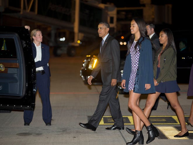 President Barack Obama arrives accompanied by daughters Malia and Sasha, right, at the international Buenos Aires airport, Argentina, early Wednesday.