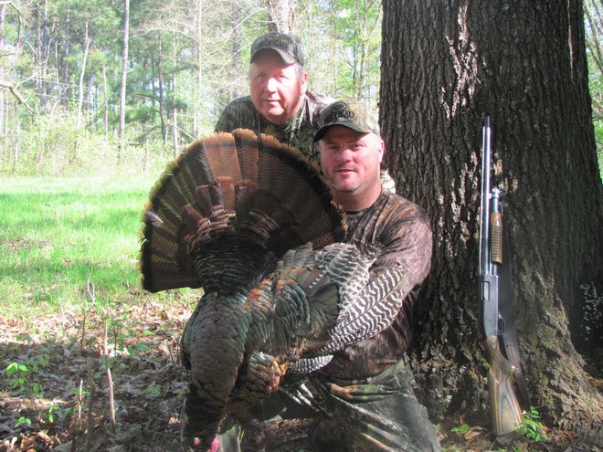 The author (kneeling) with a bird that he and Mark Payne shot that involved getting totally lost, climbing multiple ridges, winding through different hardwood bottoms, fighting briar thickets and bogging down in knee-deep mud.