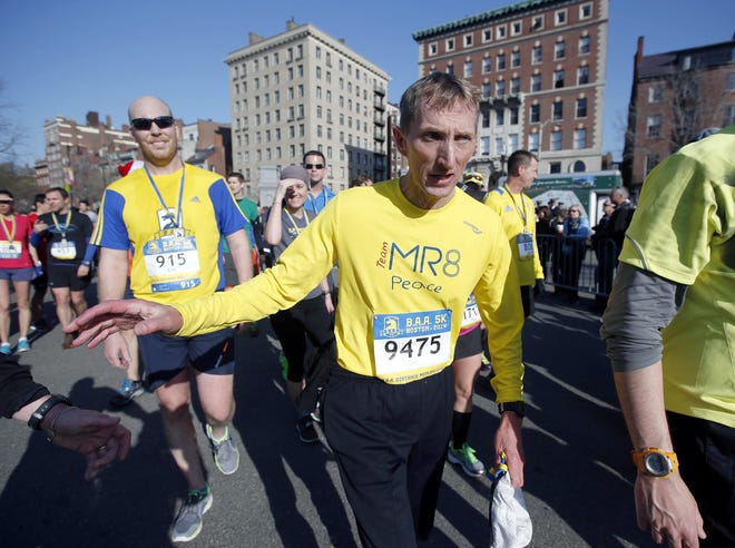 FILE - In this April 19, 2014 file photo, Boston Police Commissioner William Evans leaves the course after running in the 5-kilometer race in Boston in advance of Monday's 118th Boston Marathon. Evans, an avid runner, said Wednesday, March 23, 2016, he has no information suggesting the April 18 Boston Marathon might be targeted anew, but told The Associated Press in an interview that as a precaution he's canceling his own plan to run in the race. (AP Photo/Elise Amendola, File)