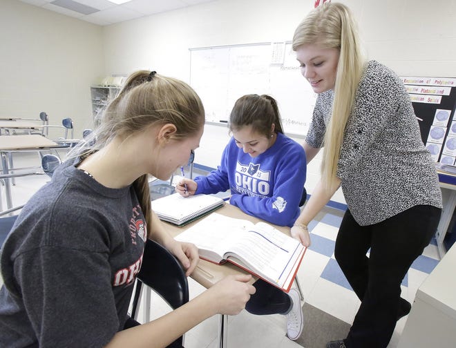 GateHouse Ohio Media / Glenn B. Dettman



Substitute Ashley Schaer (standing) helps Amanda Sebolt and Jessica Schaer with math assignments at Tuslaw High School. Local educators say they are having a hard time finding subs to fill in when the regular teacher is absent.