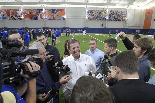 Florida head coach Jim McElwain, center, answers questions from reporters during Florida's NFL Pro Day Tuesday. Associated Press/Phelan M. Ebenhack