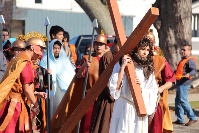 Jesus (Edwardo Gomez) carries his cross through the streets of Holland, followed by parishoners of St. Francis De Sales during the Via Crucis/Way of the Cross, Friday afternoon, March 25, 2016.

Andrea Goodell/Sentinel Staff