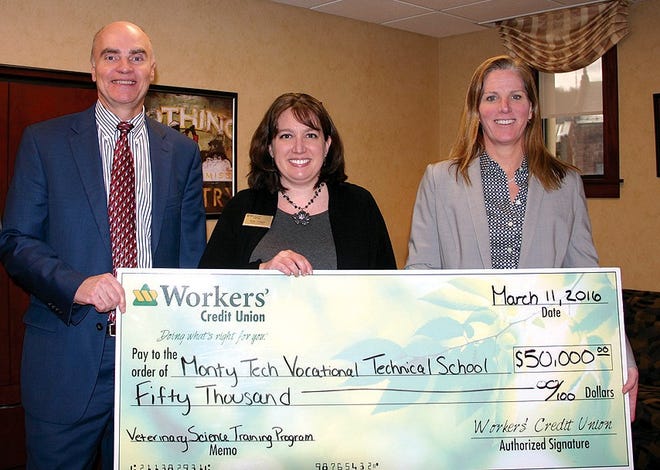 Workers’ Credit Union President and CEO Doug Petersen and Katie Trinque, branch supervisor, present a $50,000 donation to Sheila Harrity, right, superintendent-director of the Montachusett Regional Vocational Technical School District.