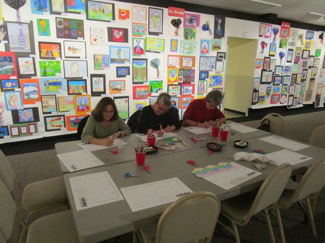 Community members color flextangle puzzles in The Haggin Museum's West Gallery surrounded by art from the 85th annual McKee Student Art Contest and Exhibition. JOY NEAS/COURTESY