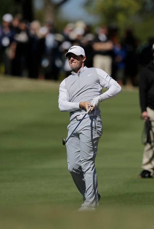 Rory McIlroy watches his approach shot on the first hole during round-robin play against Kevin Na at the Dell Match Play Championship on Friday at Austin County Club in Austin, Texas. (AP Photo/Eric Gay)