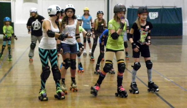 Savannah Jr. DerbyTaunts skate in pairs as they get to know each other Sunday afternoon at the Garden City Recreation Center during a meet-and-greet and open enrollment session. (Dash Coleman/Savannah Morning News)