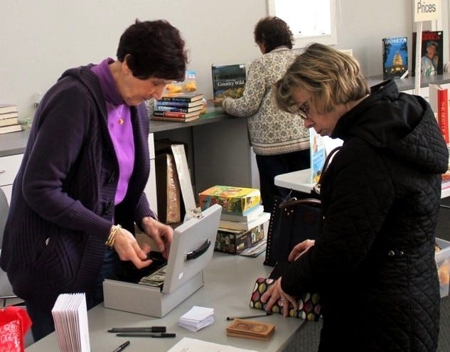 Priscilla Porter, president of the Friends of the Wareham Free Library, checks out a customer at the organization’s monthly Used Book Sale in the library.

Wicked Local Photo/Chris Shott