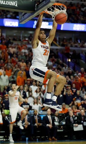 Virginia's Isaiah Wilkins (21) dunks during the second half of a college basketball game against Iowa State in the regional semifinals of the NCAA Tournament, Friday, in Chicago.