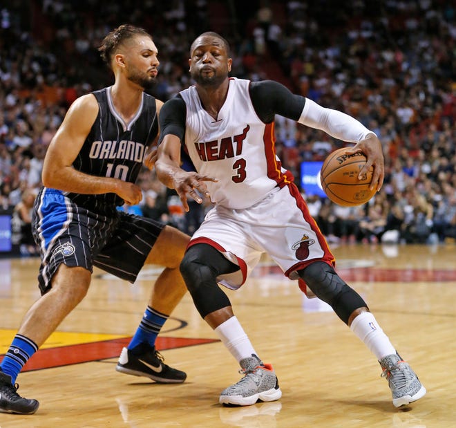 Miami Heat's Dwyane Wade (3) dribbles the ball to the basket against Orlando Magicís Evan Fournier (10) during the second half of an NBA basketball game, Friday,, in Miami