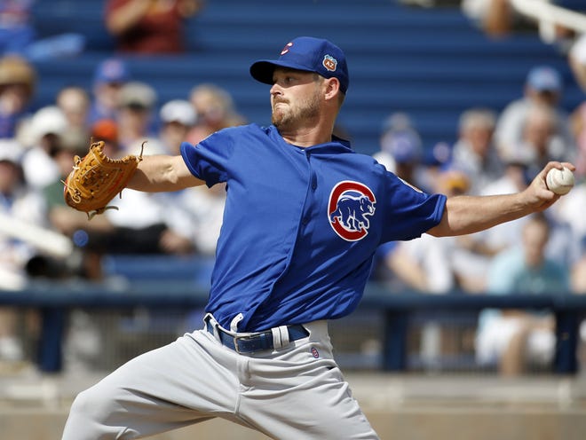 Chicago's Travis Wood throws during the first inning of a spring training game against Milwaukee on March 3 in Phoenix.