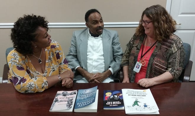 Palm Coast author Ronald Adams talks with friends Katherine Jefferson, left, and Terri Titus, the senior rehabilitation specialist who helped Adams, who is legally blind, get a computer to help him with his writing. NEWS-JOURNAL/SHAUN RYAN