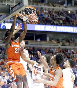 Syracuse's Tyler Roberson (21) dunks during the first half of Sunday's Midwest Regional final against Virginia in Chicago. 

AP Photo/Nam Y. Huh