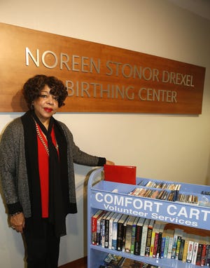 Newport Daily News Community Service Award winner Ruth Barge Thumbtzen stands with her comfort cart at Newport Hospital, where she volunteers in the Noreen Stonor Drexel Birthing Center. It is one of many volunteer tasks Thumbtzen takes on.