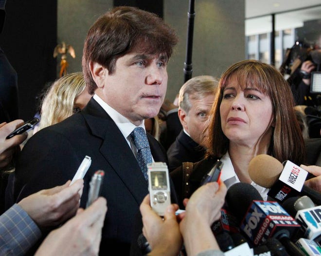 In this Dec. 7, 2011 file photo, former Illinois Gov. Rod Blagojevich, left, speaks to reporters as his wife, Patti, listens at the federal building in Chicago, after Blagojevich was sentenced to 14 years on 18 corruption counts. On Monday, March 28, 2016, the U.S. Supreme Court rejected Blagojevich's appeal of his corruption convictions that included his attempt to sell the vacant Senate seat once occupied by President Barack Obama. (AP Photo/M. Spencer Green, File)