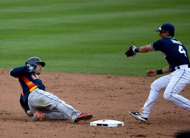 Houston Astros' Leo Heras, left, slides safely to second base, under pressure from San Diego Padres' Luis Urias, during the eighth inning of a spring training baseball game in Mexico City, Sunday, March 27, 2016. (AP Photo/Eduardo Verdugo)