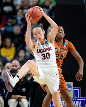 Connecticut's Breanna Stewart grabs a rebound in front of Texas’ Ariel Atkins during the first half of a college basketball game in the regional final of the women's NCAA Tournament against Texas, Monday, March 28, 2016, in Bridgeport, Conn. (AP Photo/Jessica Hill)