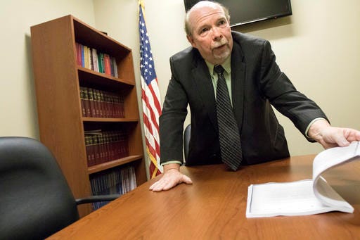DeKalb County State's Attorney Richard Schmack looks through pages of documents included as exhibits to support his vacating the conviction response to Jack McCullough's post conviction filings in his conference room at the DeKalb County Courthouse in Sycamore, Ill., Friday, March 25, 2016. Jack D. McCullough was convicted of the 1957 murder of 7-year-old Maria Ridulph in September of 2012. McCullough will appear in court on Tuesday, March 29.  (Danielle Guerra/Daily Chronicle via AP) MANDATORY CREDIT; CHICAGO TRIBUNE OUT
