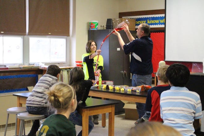 Lori Raile, registered nurse, and Reid Raile, EMS director, demonstrate how the heart pumps blood through arteries to reach other body parts as part of a healthy heart Valentine’s Day party Feb. 12 for fourth-graders at St. Francis Grade School.