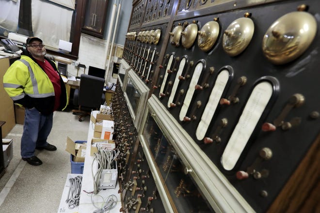 Rick Babineau, electrician for the municipal fire alarm system, takes a look at the old fire alarm system dating back to 1852 at the central fire station in downtown New Bedford. 

PETER PEREIRA/THE STANDARD-TIMES/SCMG
