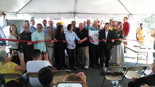 Officials from Flagler County and Palm Coast cut the red tape Monday during a ribbon-cutting ceremony to open the ramps at the new Interstate 95 interchange at Matanzas Woods Parkway in Palm Coast. NEWS-JOURNAL/MATT BRUCE