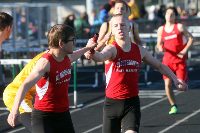 Fort Madison’s Aaron Steffensmeier hands the baton to teammate Adam Darley during the 4X800 relay at the annual Falcon Relays in West Burlington.