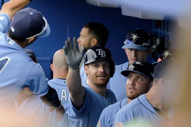Tampa Bay Rays second baseman Logan Forsythe (11) is greeted in the dugout after a solo home run during the first inning of a spring exhibition baseball game against the Toronto Blue Jays on Tuesday in Dunedin.